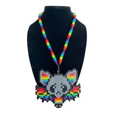 Add a pop of color to your festival or party outfit with this Rainbow Bat Kandi Necklace. Handcrafted with care, this beaded necklace features a unique design that will surely make you stand out from the crowd. The necklace is perfect for those who love to express themselves through their fashion choices and want to make a statement. Made by Byte Size Kandi, this necklace is a must-have for any jewelry collection. It is perfect for those who love to show off their love for all things colorful and vibrant. Whether you are attending a rave, party, or costume event, this necklace will complement your outfit perfectly. Rainbow Beaded Necklaces For Party, Colorful Round Beads Necklaces For Party, Fun Festival Jewelry With Round Beads, Colorful Beaded Chain Necklaces For Party, Fun Multicolor Necklaces For Gifts, Handmade Rave Jewelry For Party, Fun Multicolor Necklace For Gift, Festival Multicolor Beaded Necklaces, Colorful Beaded Chain Necklace For Party