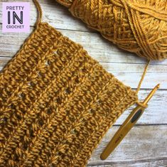 a crochet project with yarn and knitting needles