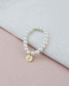 All time classic pearls bracelet with added initial to complete your look. Choose from silver, rose gold, or gold initials to match with your personality and give a modern touch on a traditional style.Great for bride or for birthday gifts, flower girls, brides or or bridesmaids to wear on the wedding day. ** Please put the preferred letter initial on notes upon checkout ** This listing is only for 1 bracelet. Bracelet is measured to approximately 7 - 8 inches, however, it can stretch to match wr Pearls Bracelet, Ivory Pearl, Gold Initial, Flower Girls, Monogram Initials, Silver Rose Gold, Pearl Bracelet, On Shoes, Traditional Style