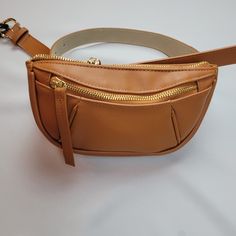 Inc Belt Bag, Tan Cognac Color With Gold Metal Accents Cute And Stylish Belt Bag Color: Cognac Tan Color Gold Zipper On Top To Close On Front Pocket And Gold Hardware, All Metal Large Nwt Materials, Pebble Texture Man Made Materials, Not Leather. 8 1/2 Long, X 4 1/4 High X 2 1/2 Inch Dept, Expand Larger Chic Brown Shoulder Bag With Pockets, Brown Crossbody Belt Bag With Zipper Closure, Everyday Brown Belt Bag With Zipper Pocket, Brown Belt Bag With Zipper Closure, Brown Belt Bag With Zipper Closure As Shoulder Bag, Versatile Brown Belt Bag For On-the-go, Chic Brown Belt Bag With Zipper Closure, Chic Brown Bags With Pockets, Chic Brown Bag With Pockets