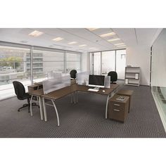 an empty office with two desks and chairs