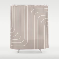 a beige shower curtain with white lines on the bottom and bottom, against a gray background