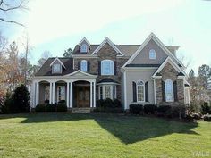 a large house with lots of windows in the front yard