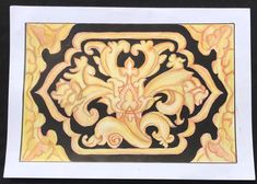 an intricately designed piece of wood with yellow and black designs on the bottom half