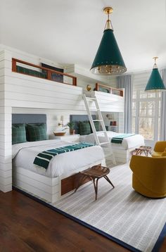 a room with two beds and a ladder hanging from the ceiling in front of it