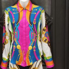 Versace Multicolor Printed Long Sleeve Silk Blouse With Gold Baroque Medusa Details, Concealed Buttons Along The Front, With Gold Button At The Top Of The Collar. Size: Italian 38 / 2 U S It Features A Pointed Collar Neckline And A Button-Front Closure With A Concealed Placket. The Top Button Is Exposed At The Throat And Features A Gold Medusa Head Embossed Design. This Blouse Has Long Sleeves With A Gold Metal Medusa Embossed Button At Each Cuff And Has Rounded Hemlines. It Is Composed Of Multi Designer Multicolor Formal Tops, Designer Formal Multicolor Tops, Elegant Fitted Baroque Print Tops, Luxury Multicolor Silk Tops, Elegant Long Sleeve Blouse With Baroque Print, Elegant Baroque Print Tops For Spring, Elegant Long Sleeve Baroque Print Blouse, Elegant Multicolor Buttoned Tops, Elegant Multicolor Blouse With Buttons