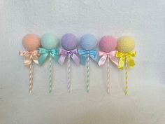 there are five different colored lollipops with bows on them