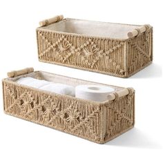 two wicker baskets with lids and handles, one is holding toilet paper in it