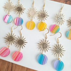 the dangles are all different colors and have sunburst designs on them