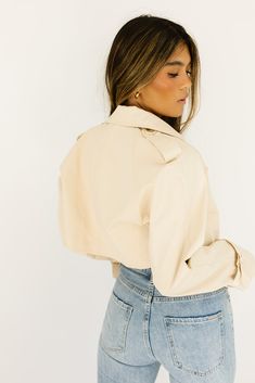 this cropped trench coat-esque jacket will take any spring outfit to the next level. it features chic tortoise shell buttons + has the most perfect cropped silhouette. whether you throw it on to elevate a basic outfit or use it as the focal point of your ensemble, it’s guaranteed to get you allll the compliments. butter // lapel collar, buttons, cuffed sleeves paired with our lotti tank + sicily distressed denim model is 5'7" + wearing a small measurements are approximate + taken while laying fl Chic Spring Button-up Cropped Jacket, Spring Cropped Jacket With Relaxed Fit And Button-up, Medium Wash Cropped Button-up Jacket, Spring Button-up Cropped Denim Jacket, Utility Button-up Cropped Jacket With Pockets, Cropped Trench Coat, Basic Outfits, Cuff Sleeves, Distressed Denim