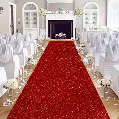 a red carpet is on the floor in front of white chairs and tables with flower centerpieces