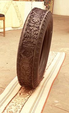 an old tire sitting on top of a rug