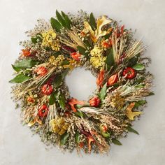 a wreath made out of dried flowers and leaves