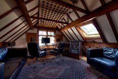 a living room filled with furniture and lots of windows