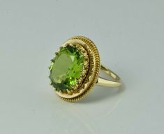 "Vintage 14K Yellow Gold Peridot Ring, 4.66 carat, 9 x12 mm lime green faceted oval stone, fleur de lis prongs, rope twist surround, 5/8\" across top, Ring size 2.25, Circa 1950, 4 grams Stock # BB234R20 Most rings are sizable for a small fee. If the ring you are considering is the incorrect size contact us for a quote. This listing contains photographs of the actual item you will receive. Our items are in excellent condition with little or no signs of wear and many are one of a kind pre-owned e Elegant Lime Green Oval Rings, Classic Lime Green Oval Jewelry, Gold Peridot Ring, Sparkly Ring, Gold Diamond Band, Vintage Fine Jewelry, Rope Twist, Art Women, Peridot Ring