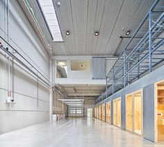 the inside of a large building with metal railings and doors on either side of it