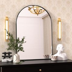 a dresser with a mirror and vase on it