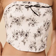 Cropped Length, Corset Style, Strapless, Delicate Tie Detail, Back Zipper Closer, Made With Rayan And Polyester White Fitted Floral Print Tube Top, Fitted White Floral Print Tube Top, White Feminine Bandeau Top, Feminine White Bandeau Top, White Floral Print Tube Top For Summer, White Cropped Tube Top For Summer, White Floral Print Tube Top For Spring, Elegant Cotton Tube Top For Summer, White Strapless Cotton Crop Top