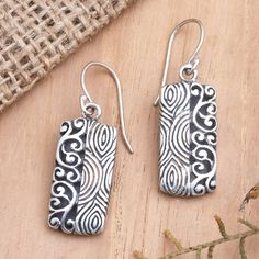 Half fingerprint motif, half curling vine, Wayan Asmana's dangle earrings are 100% fun. Balinese artisans use sterling silver to create the earrings, engraving the precious metal with two distinct patterns in a combination finish. Engraved Sterling Silver Adjustable Earrings, Artisan Sterling Silver Etched Earrings, Etched Sterling Silver Dangle Earrings, Artisan Etched Sterling Silver Earrings, Rolling Mill, Earrings Ideas, Poly Clay, Silver Dangle Earrings, Sterling Silver Dangle Earrings