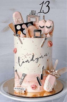 a birthday cake decorated with makeup and cosmetics