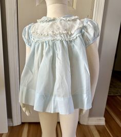 Vintage Baby dress, no size tag but I'm estimating it at 18-24 months. My mannequin is a 2T and this fits a little snug  Cute  collar with lace and embroidery detail  Machine wash, back button closure Sheer crepe fabric is light weight Clean smoke free, pet free home Feel free to ask questions as I don't take returns Thanks for looking! Cute Blue Dress With Peter Pan Collar, Fitted Ruffled Dresses For Bedtime, Cute Fitted Baptism Dress With Lace Trim, Blue Dresses With Lace Collar For Daywear, Fitted Cotton Baptism Dress With Lace Trim, Blue Lace Trim Dress For Baptism, Cotton Short Sleeve Baptism Dress, Cotton Baptism Dress With Short Sleeves For Daywear, Light Blue Cotton Dress For Baptism