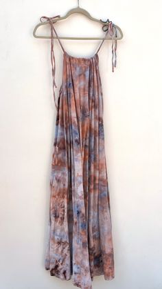 One of a kind hand ice dyed flowy maxi dress with tie shoulder spaghetti straps. Shape is very forgiving so it can fit many sizes. 100% Cotton Individually ice dyed with non-toxic dyes. Prewashed - Wash with like colors in cold water & tumble dry low. What is Ice Dyeing? It’s a form of dying clothes were the fabric is first covered in ice, then the dye is applied on top. As the ice melts it creates a OOAK watercolor effect. This item was a fast fashion closeout style saved from its most likely future of incineration or the landfill and given a second chance at a new colorful life! Product Measurements Size US Bust Length Underbust XS 2 33.9 48 40.6 S 4 35.4 48.8 42.1 M 6 37 49.6 43.7 L 8/10 39.4 50.4 46.1 XL 12 41.7 51.2 48.4 How To Dye Shoes, Handwoven Tapestry, Ice Dye, Colorful Life, Flowy Maxi Dress, Ice Dyeing, Dress With Tie, Second Chance, British Indian