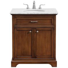 a bathroom vanity with a marble top and two faucets on the sink area