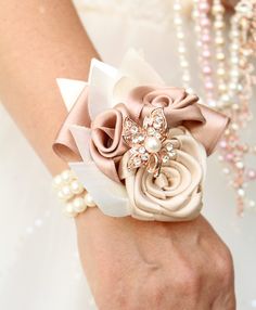 a close up of a person's hand wearing a bracelet with flowers on it