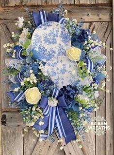 a blue and white wreath with flowers on it