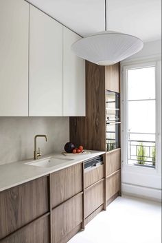 a kitchen with wooden cabinets and white counter tops