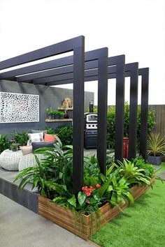 an outdoor living area with lots of plants