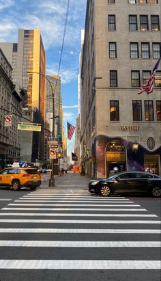 a city street filled with lots of traffic and tall buildings under a blue cloudy sky