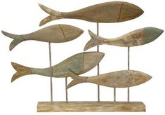 five wooden fish on sticks in the shape of an ocean animal, each with different colors and sizes