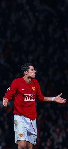 a man in red shirt and white shorts playing soccer