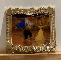 an image of beauty and the beast on display in a gold frame with white background