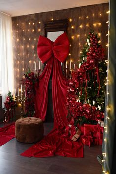 a living room decorated for christmas with red decorations