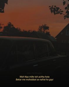 an old car parked in front of a house at sunset with a quote written on the side