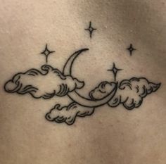 a woman's stomach with clouds and stars on it