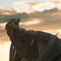 a large black dragon standing on top of a lush green field