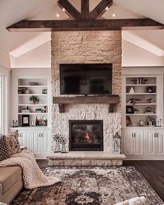 a living room with a fireplace and entertainment center