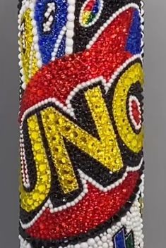 a cell phone case made out of beads and beaded with the word uno on it