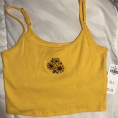 Women’s Hollister Yellow Baby Cami/Crop Top With Adjustable Straps & Embroidered Sunflower On The Front. Nice Yellow Color And Material Is Thick Enough You Could Go Braless. Size Xs. Cute Floral Embroidery Summer Tops, Fitted Cotton Tank Top With Floral Embroidery, Casual Fitted Tank Top With Floral Embroidery, Fitted Casual Tank Top With Floral Embroidery, Fitted Yellow Tops With Sunflower Print, Fitted Sunflower Print Top For Spring, Casual Fitted Floral Embroidery Tank Top, Sunflower Print Beach Tops For Summer, Sunflower Print Tops For Summer Beach