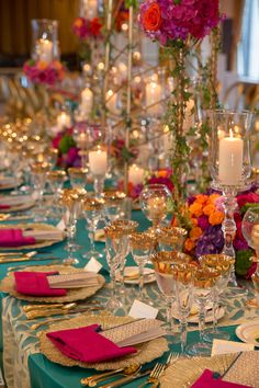 the table is set with candles and place settings