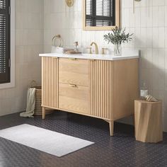 a bathroom with a sink, mirror and rug