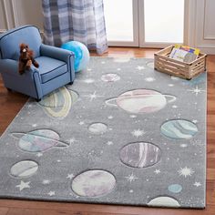 a child's room with a gray rug and blue chair