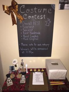 a blackboard with writing on it next to a table covered in confection items