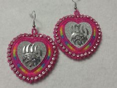 Hand-made beaded earrings: Colors: Pink w/florescent rainbow middle: Bearclaw  Closure: Hook size: 2 inches Multicolor Heart Beads Earrings For Gift, Handmade Multicolor Heart-shaped Beaded Earrings, Handmade Multicolor Heart Beaded Earrings, Gift Multicolor Heart Beaded Earrings, Multicolor Beaded Earrings With Silver Beads For Gift, Multicolor Silver Beaded Earrings As Gift, Nickel Free Rainbow Beaded Earrings For Gifts, Rainbow Beaded Round Earrings As Gift, Adjustable Multicolor Earrings With Silver Beads