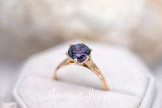 a close up of a ring with a blue stone