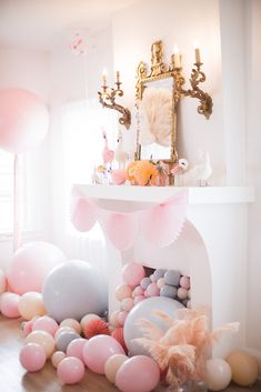 a room filled with balloons and other decorations