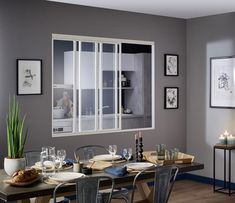 a dining room table with plates and glasses on it